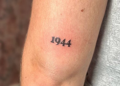 Arm tattoo of '1944' at Cosmopolitan Beauty Bar, Springwater, Ontario, CA.