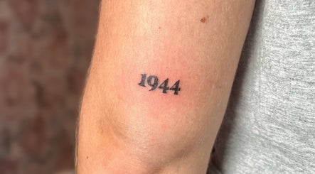 Arm tattoo of '1944' at Cosmopolitan Beauty Bar, Springwater, Ontario, CA.