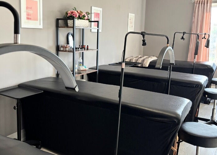 Cosmopolitan Beauty Bar spa room with treatment beds in Springwater, Ontario, CA, inviting tranquil decor.