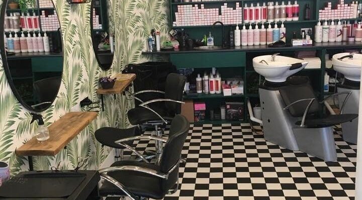 Stylish salon interior at Hair and Tan by Sandra, Elgin, Scotland, GB with checkerboard floor and elegant decor.