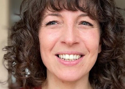 Close-up of smiling woman with curly hair at The Curl Studio, Cullompton, England, GB.