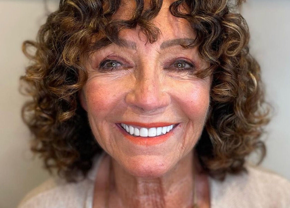 Happy client with curly hairstyle at The Curl Studio, Cullompton, England, GB, showcasing beautiful salon results.