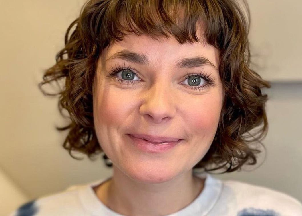 Smiling client with a chic curly hairstyle at The Curl Studio, Cullompton, England, GB.