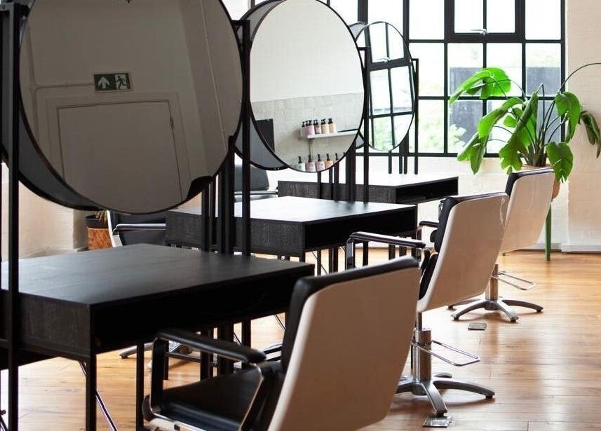 Elegant salon interior at Hannah Domney - Hackney, featuring styling stations in London, England, GB.