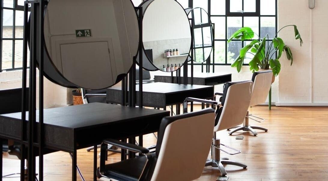 Elegant salon interior at Hannah Domney - Hackney, featuring styling stations in London, England, GB.