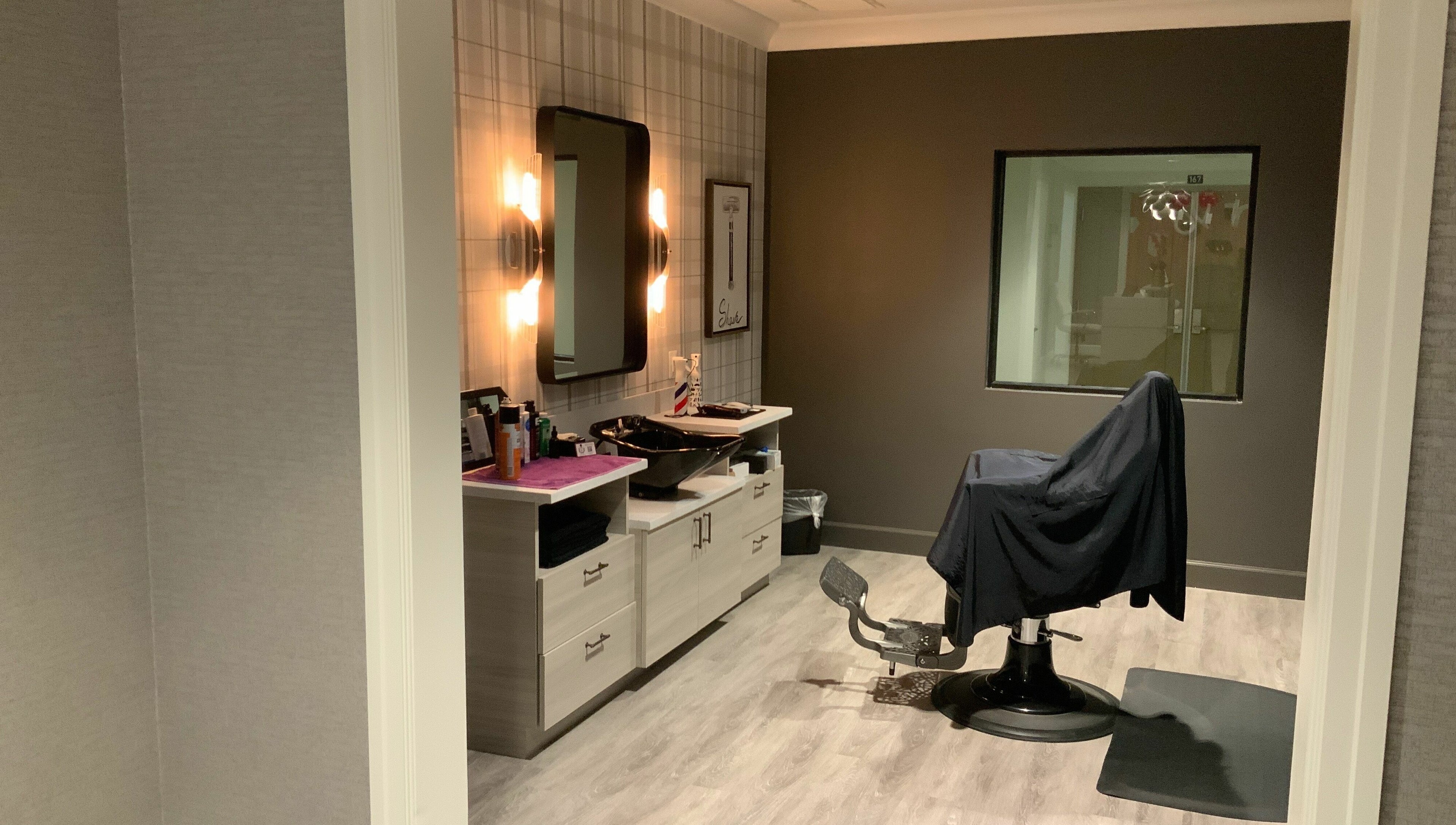 Modern salon room at Indulge at Sky Bridge at Town Center, Upper Marlboro, Maryland, US, with styling chair.