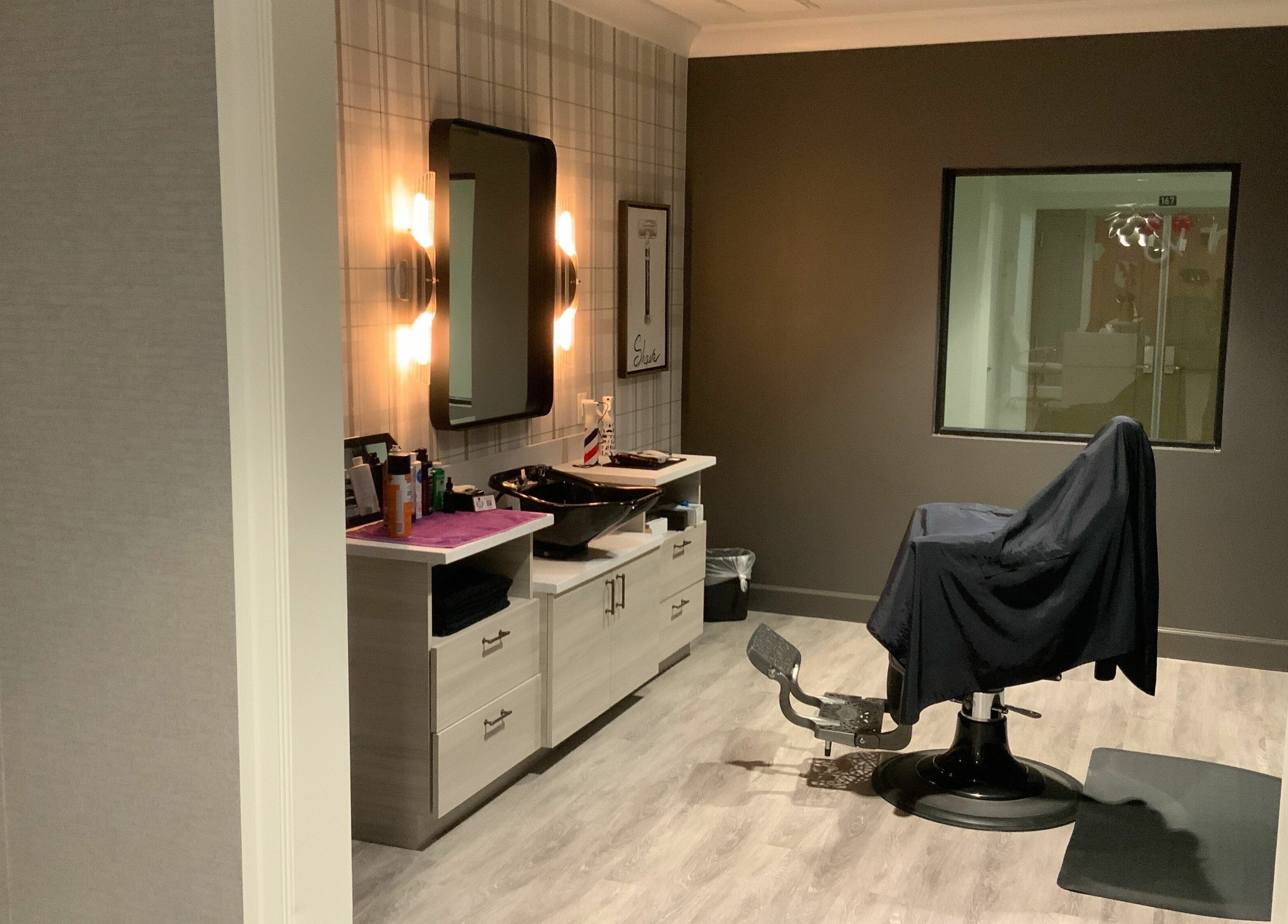 Modern salon room at Indulge at Sky Bridge at Town Center, Upper Marlboro, Maryland, US, with styling chair.