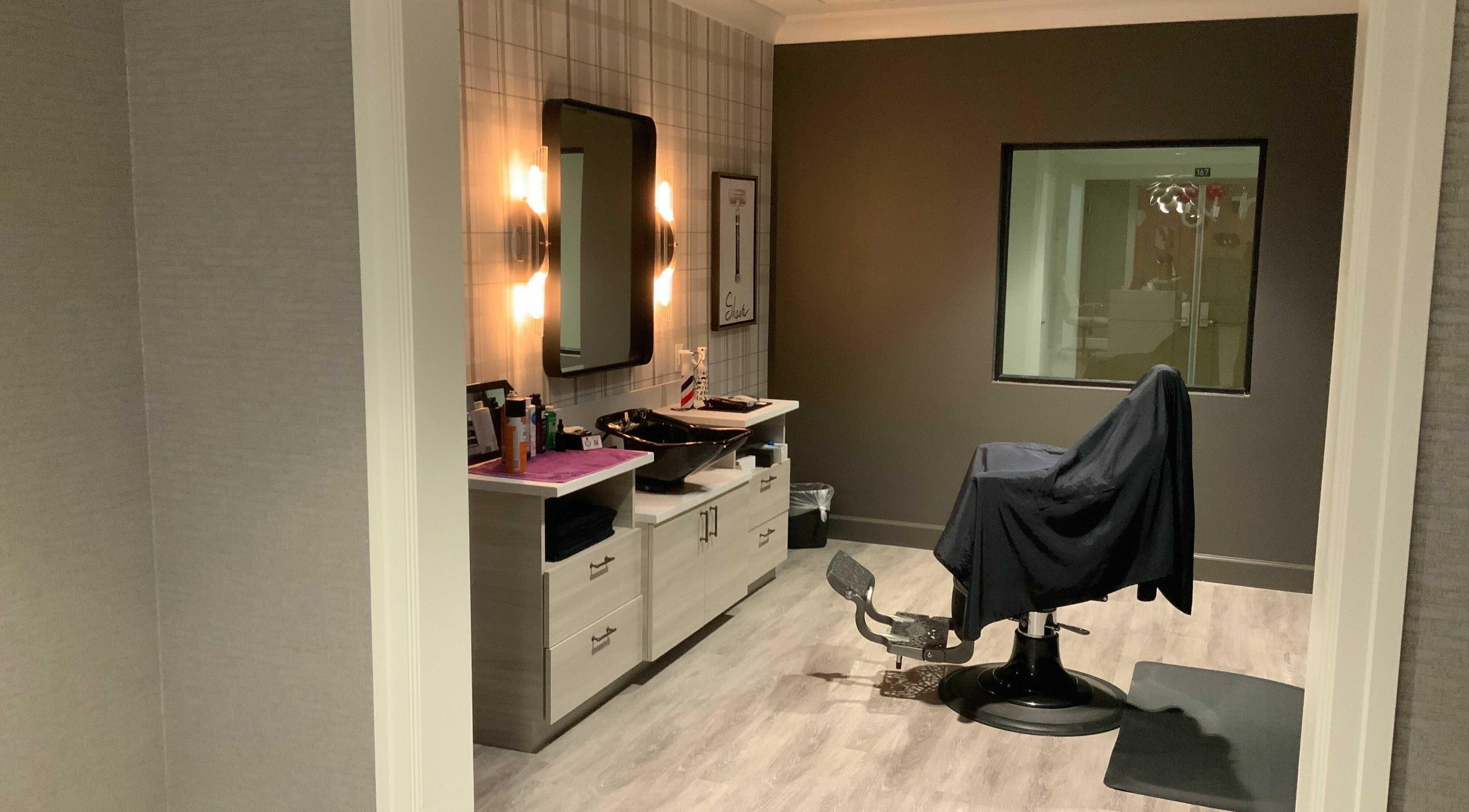 Modern salon room at Indulge at Sky Bridge at Town Center, Upper Marlboro, Maryland, US, with styling chair.