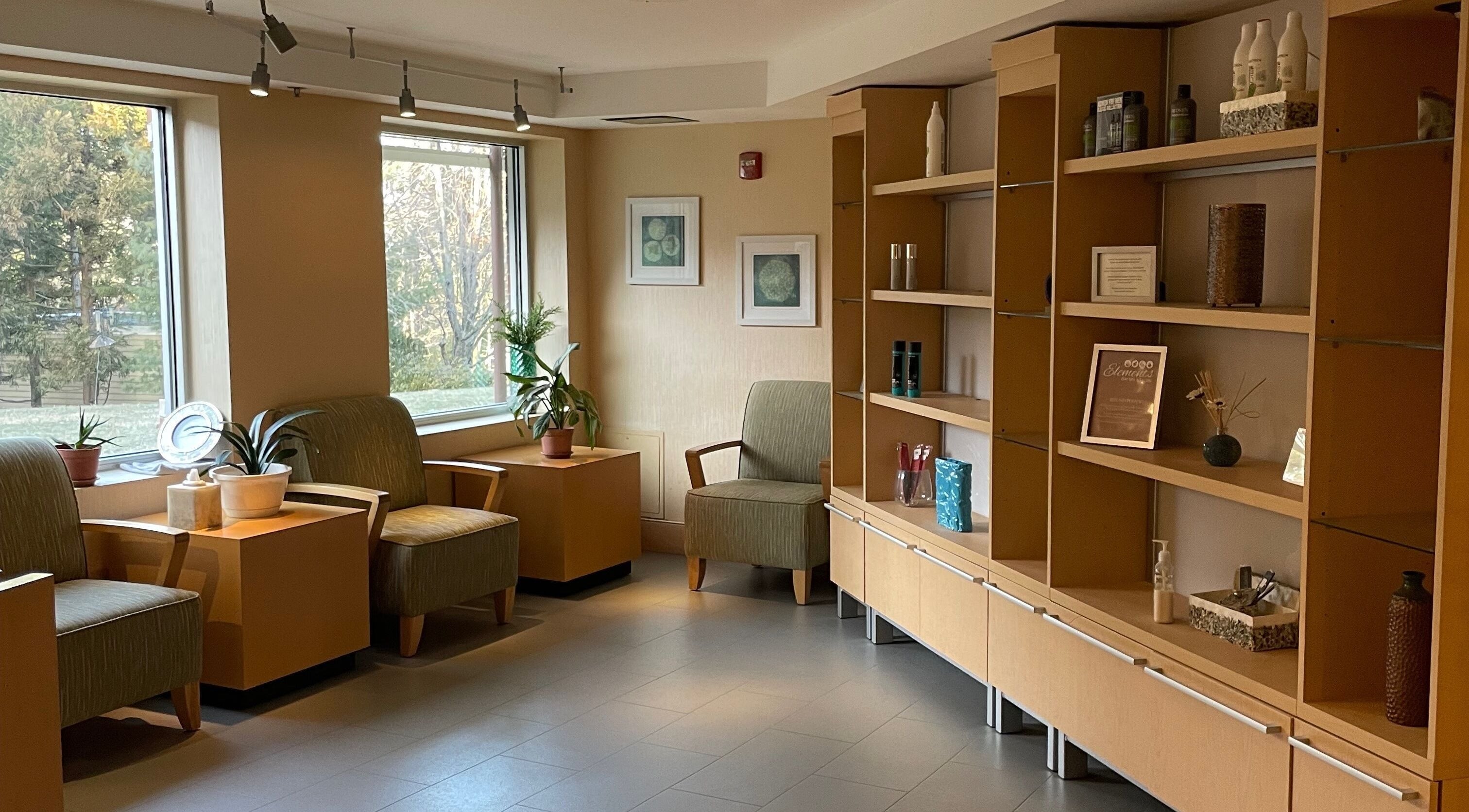 Cozy lounge area at North Hill Elements Day Spa and Salon in Needham, Massachusetts with chairs and decor.