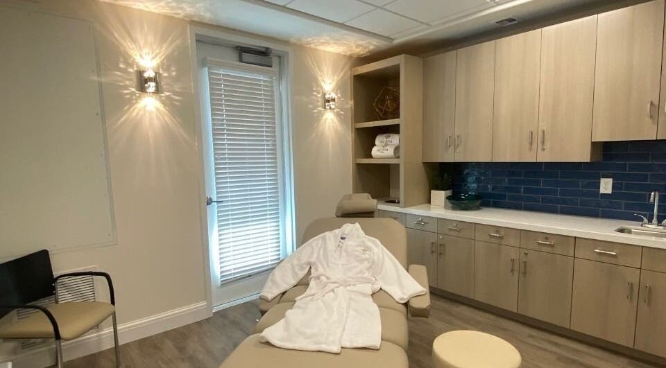 Relaxing spa room at ACOYA Troon Spa Sensi Salon in Scottsdale, Arizona, US. Features a massage table with a robe.