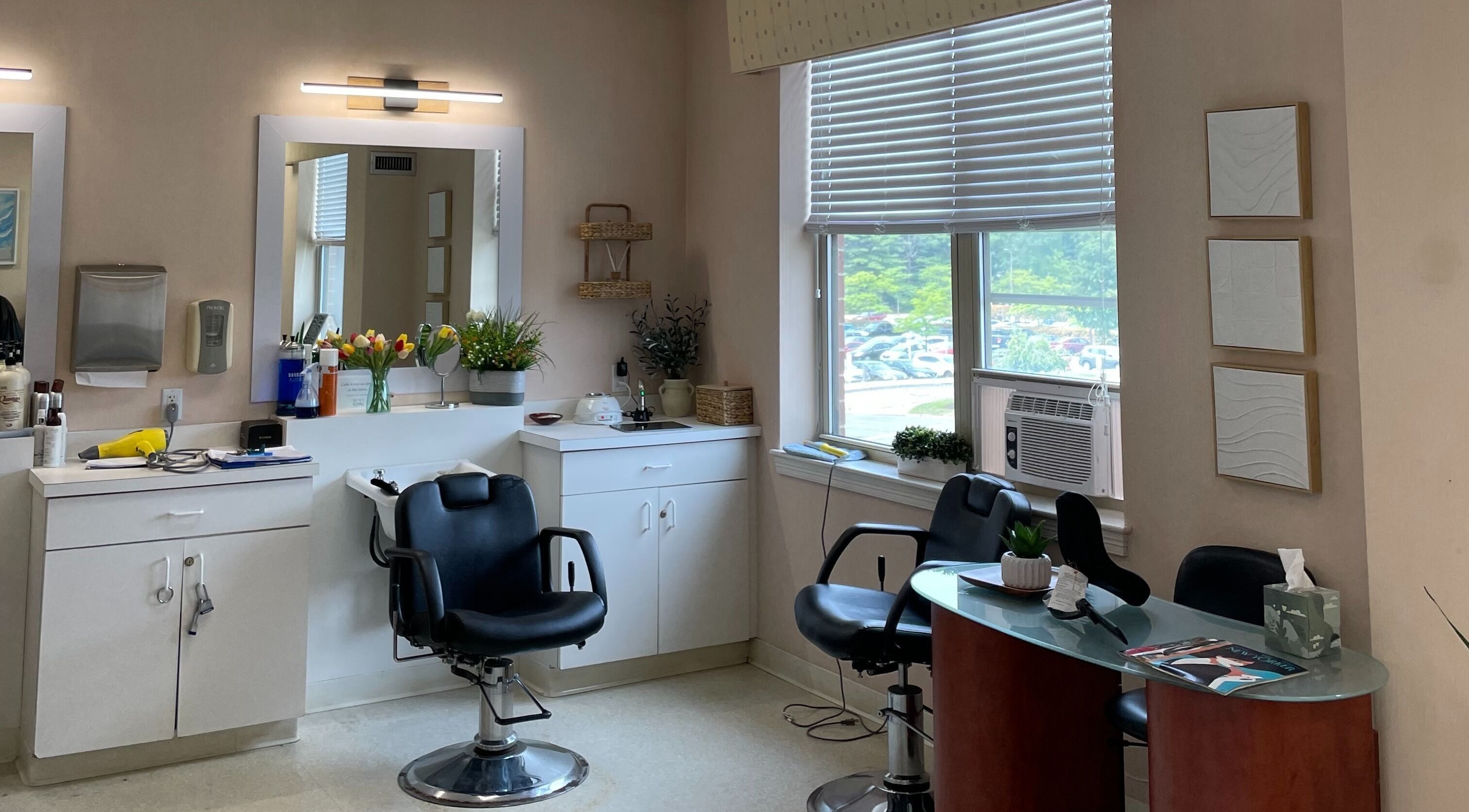 Chic salon interior at Whitney Place Salon, Natick, Massachusetts, US, featuring stylish chairs and decor.