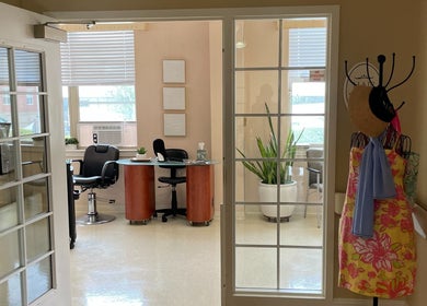 A welcoming entry into Whitney Place Salon, Natick, Massachusetts, US, featuring stylish chairs and decor.