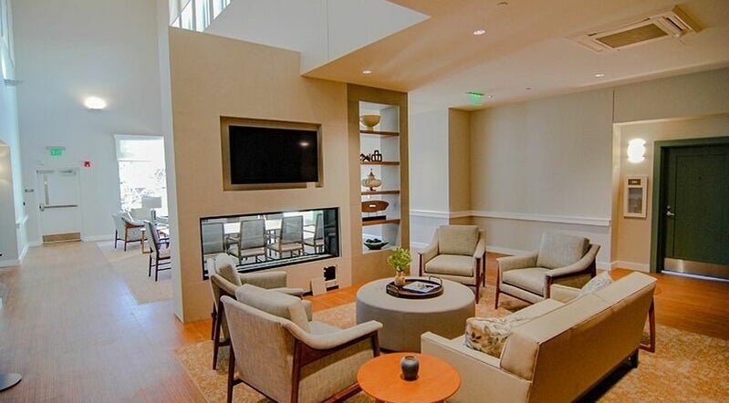 Relaxing lounge at Cordwainer Bliss Salon, Norwell, Massachusetts, US, featuring cozy seating and modern decor.