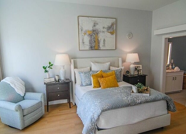 Cozy bedroom at Cordwainer Bliss Salon, Norwell, Massachusetts, US with elegant decor and warm lighting.