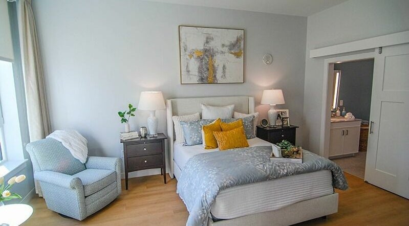 Cozy bedroom at Cordwainer Bliss Salon, Norwell, Massachusetts, US with elegant decor and warm lighting.