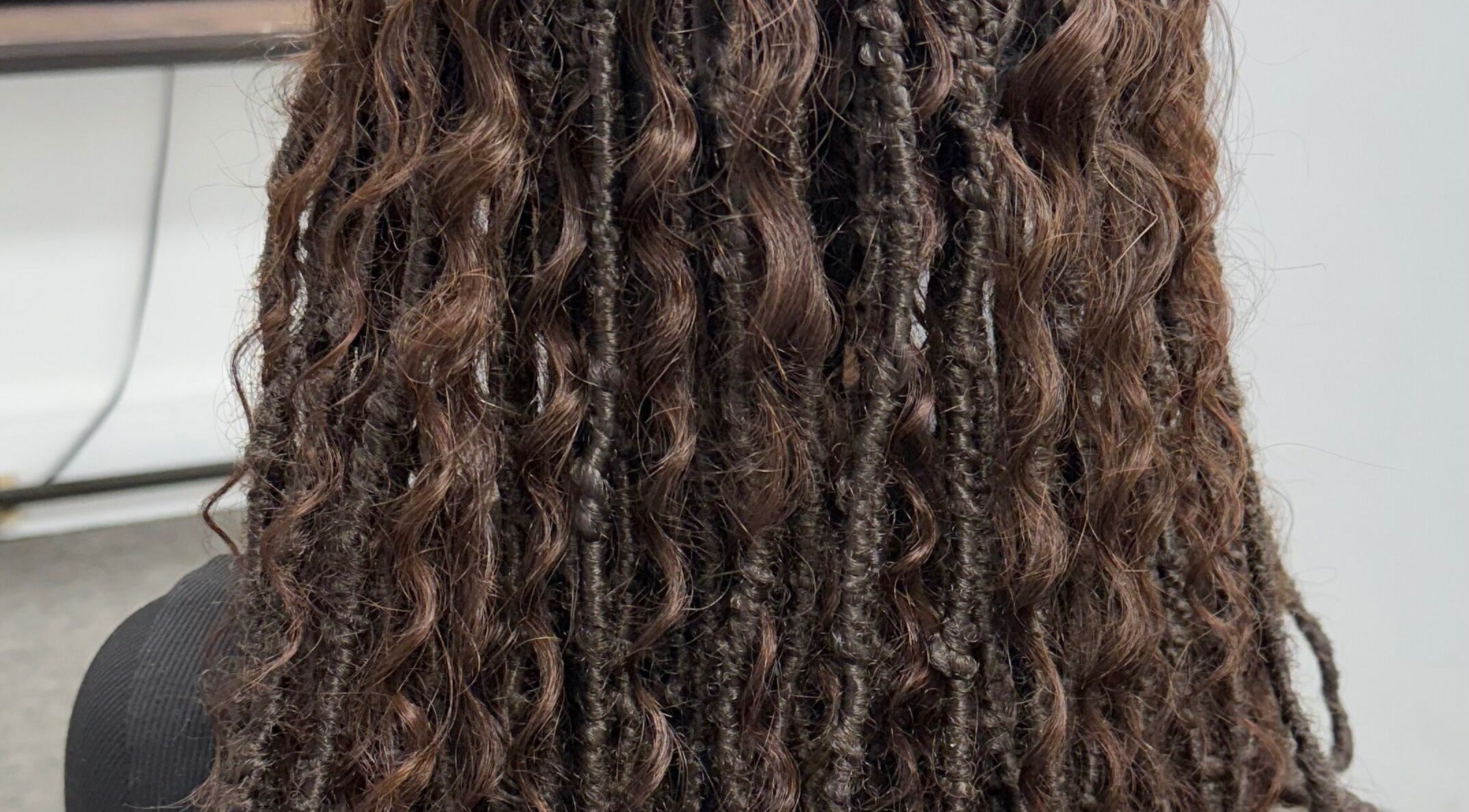 Intricate braided hairstyle at Wear A Crown Hair, Port Chester, New York, US.