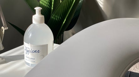 Hand sanitizer bottle on table at Beauty By Rosy in Gedling, England, GB, highlighting hygiene focus.