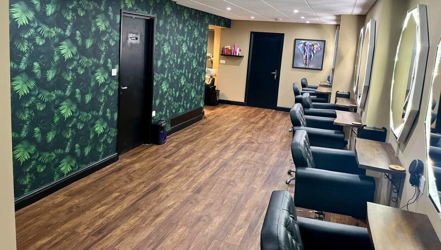 Elegant salon interior at Jake Weston Hair Transformations, Grantham, England, GB, featuring stylish chairs and mirrors.