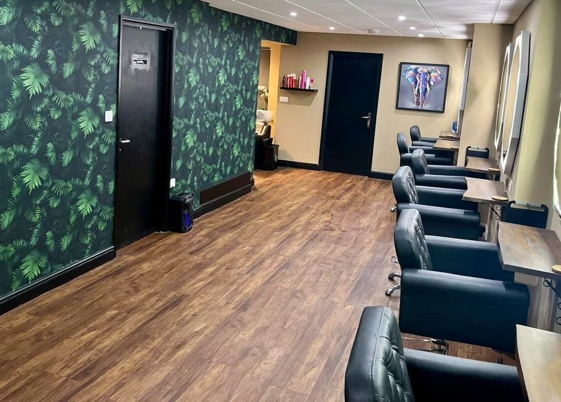 Elegant salon interior at Jake Weston Hair Transformations, Grantham, England, GB, featuring stylish chairs and mirrors.