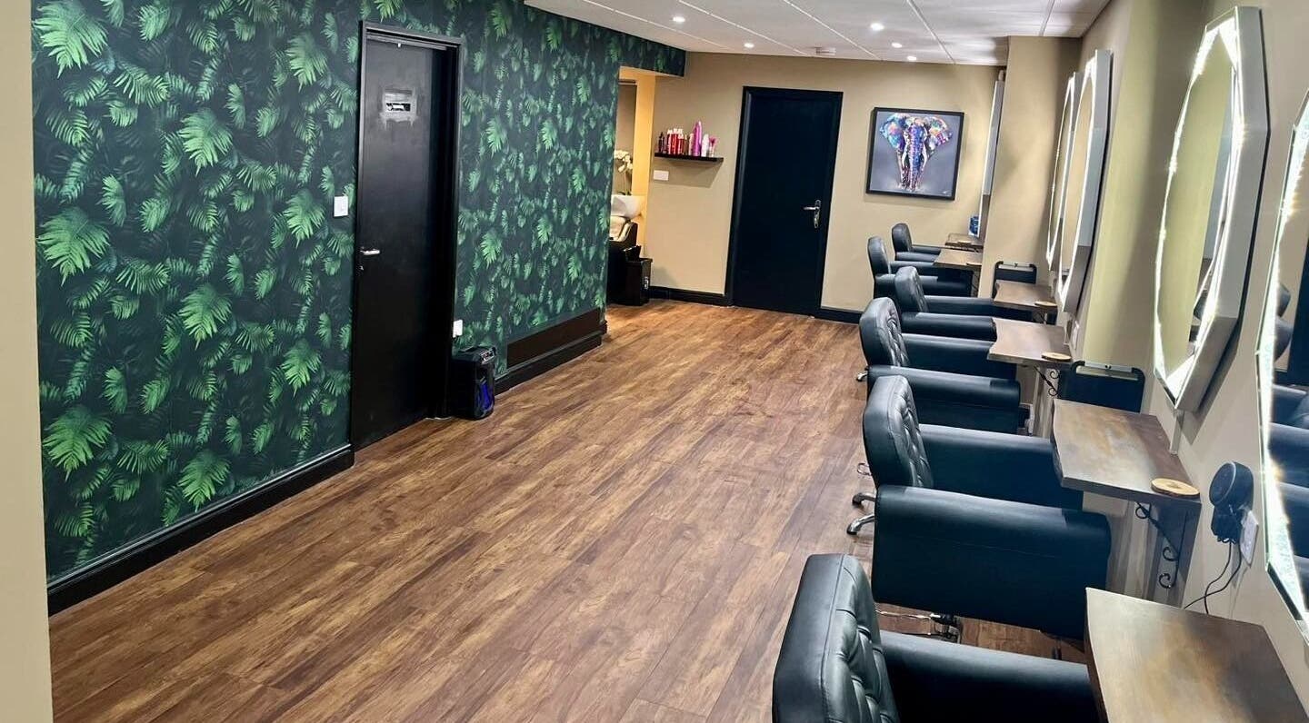 Elegant salon interior at Jake Weston Hair Transformations, Grantham, England, GB, featuring stylish chairs and mirrors.
