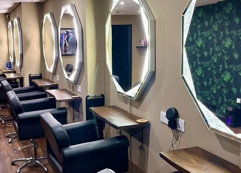 Sleek salon stations with octagonal mirrors at Jake Weston Hair Transformations, Grantham, England, GB.