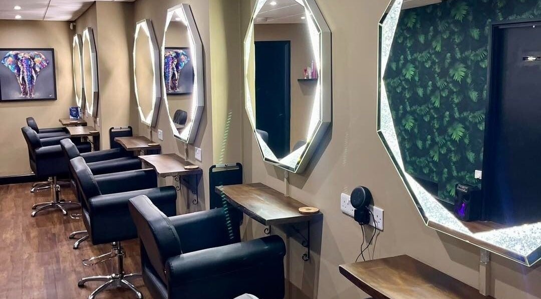 Sleek salon stations with octagonal mirrors at Jake Weston Hair Transformations, Grantham, England, GB.