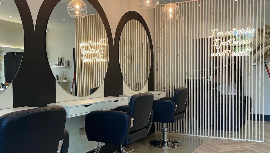Modern salon interior at Hairbytamarakelly, Leeds, England, GB with stylish mirrors and seating.