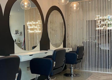 Modern salon interior at Hairbytamarakelly, Leeds, England, GB with stylish mirrors and seating.