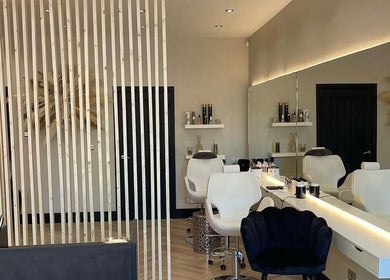 Elegant interior of Hairbytamarakelly salon in Leeds, England, GB featuring stylish chairs and modern decor.