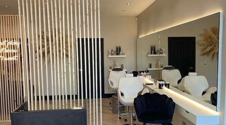 Elegant interior of Hairbytamarakelly salon in Leeds, England, GB featuring stylish chairs and modern decor.