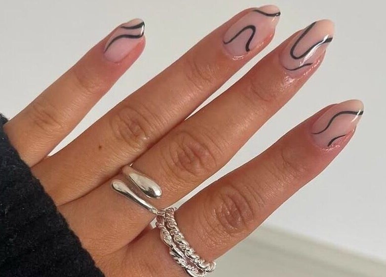 Stylish nail art design at Nimmos Nails and Beauty, Whitburn, Scotland, GB. Featuring black wavy patterns.