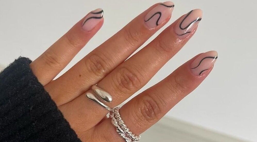 Stylish nail art design at Nimmos Nails and Beauty, Whitburn, Scotland, GB. Featuring black wavy patterns.