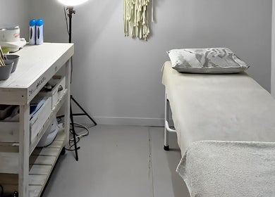 Calm treatment room at Permalicious Ink, Beauty and Aesthetics in Sandton, Gauteng, ZA, featuring a massage table.