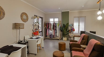 Stylish interior of Permalicious Ink, Beauty and Aesthetics in Sandton, Gauteng, ZA with cozy seating and decor.