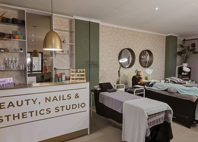 Permalicious Ink, Beauty and Aesthetics in Sandton, Gauteng, ZA. Modern salon interior with treatment beds and products.
