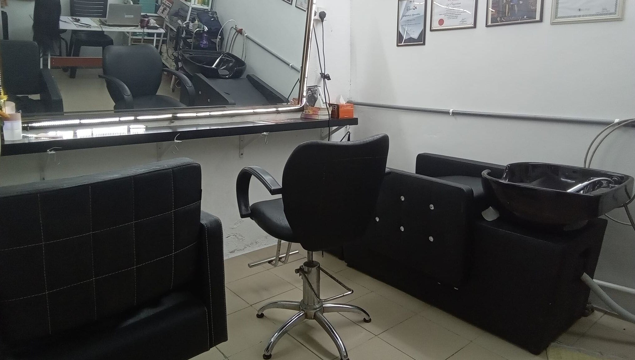 Hair styling station at Aora Spa and Wellness Kuala Langat, Telok Panglima Garang, Selangor, MY, showcasing chairs and sink.