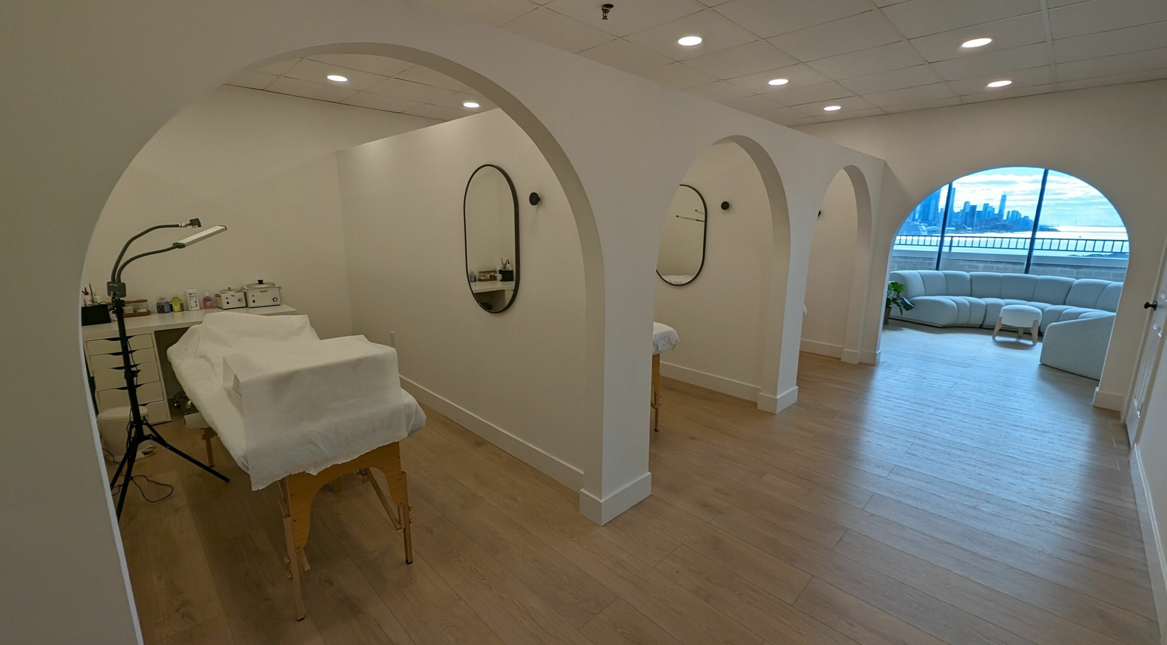 Tranquil interior of East Coast Lash Bar in Guttenberg, New Jersey, US, featuring elegant arches and soothing decor.
