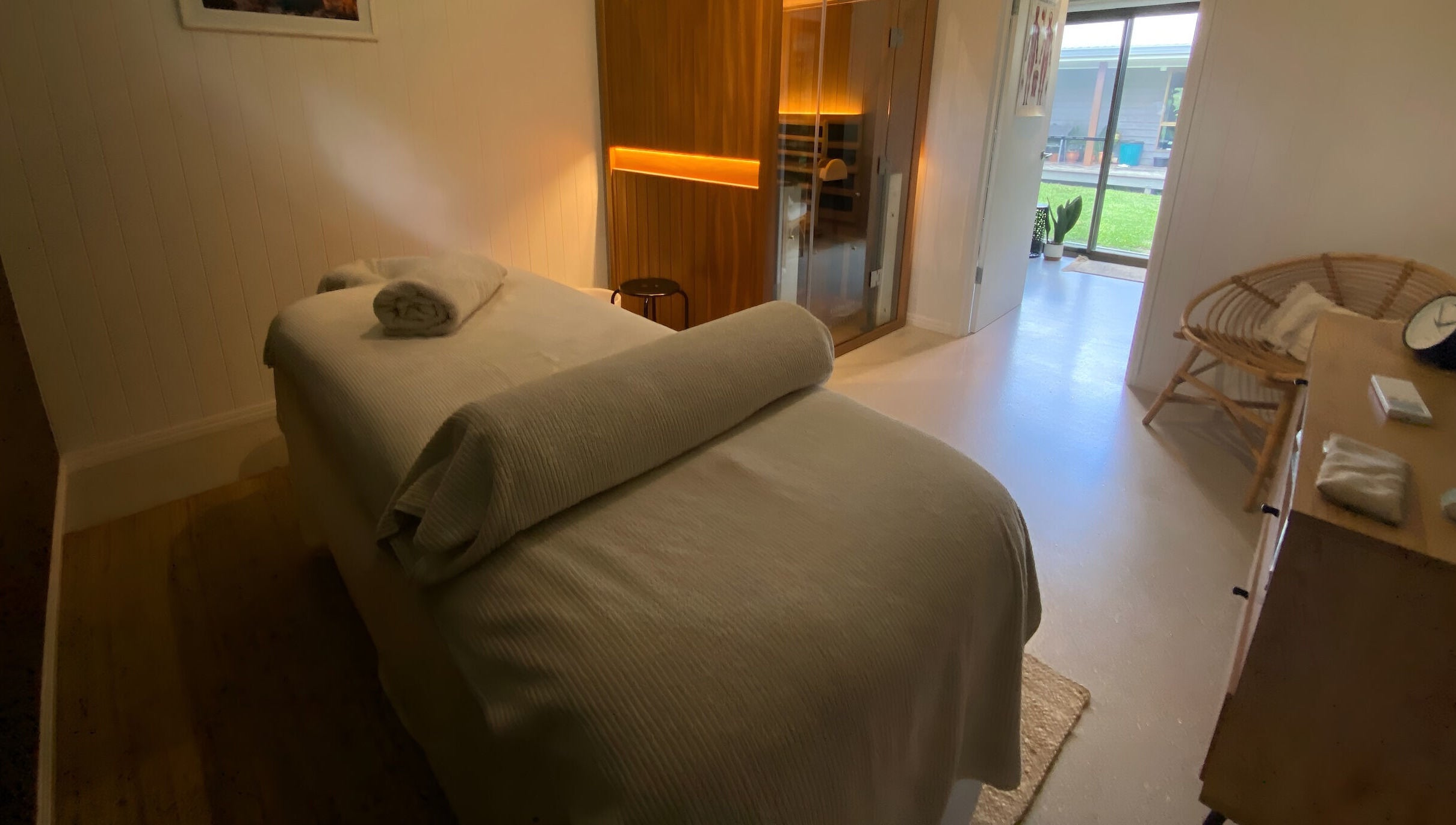 Relaxing spa room at Amaroo Wellness, Landers Shoot, Queensland, AU, featuring a massage table and ambient lighting.