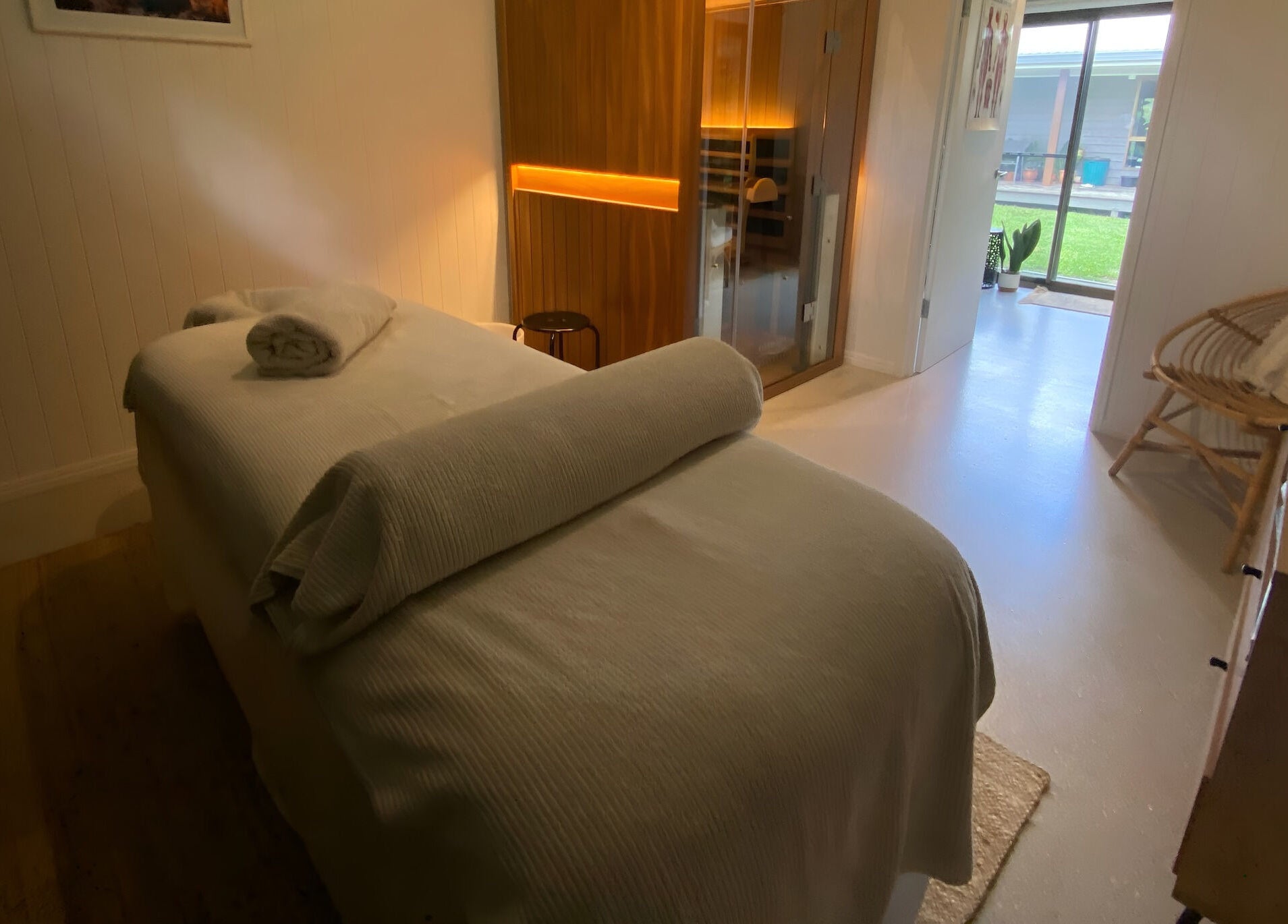 Relaxing spa room at Amaroo Wellness, Landers Shoot, Queensland, AU, featuring a massage table and ambient lighting.