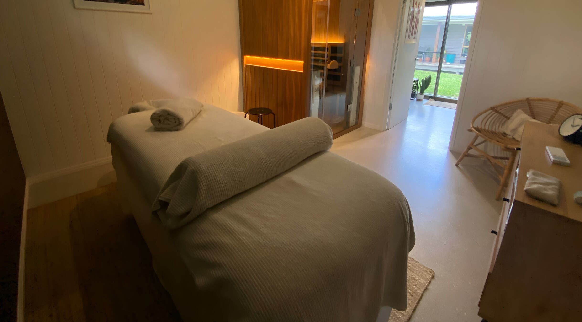 Relaxing spa room at Amaroo Wellness, Landers Shoot, Queensland, AU, featuring a massage table and ambient lighting.