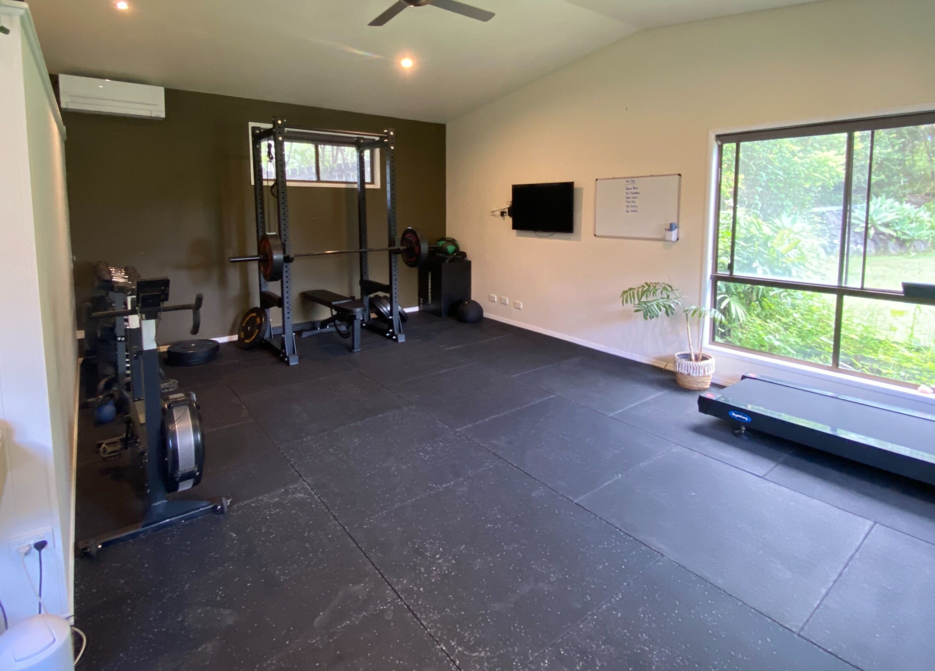 Bright gym at Amaroo Wellness in Landers Shoot, Queensland with modern equipment and lush garden views.