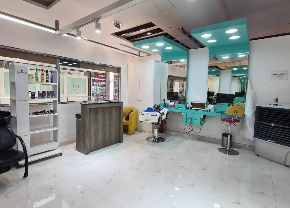 Elegant salon interior at Katakeet Kids Saloon, Dubai, Dubai, AE, featuring styling chairs and modern decor.