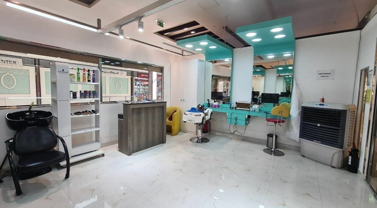 Elegant salon interior at Katakeet Kids Saloon, Dubai, Dubai, AE, featuring styling chairs and modern decor.