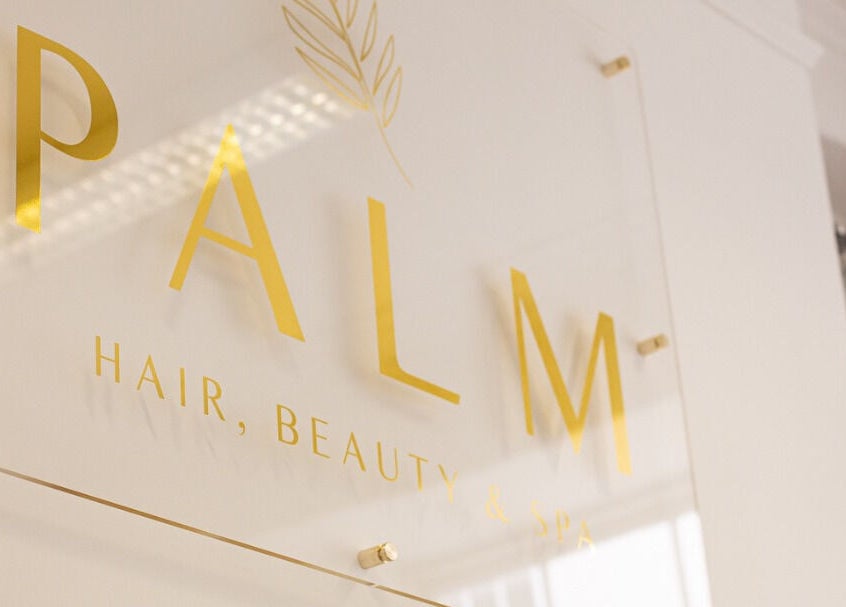 Elegant Palm Spa signage in Torquay, England, GB, showcasing sleek gold lettering on a modern backdrop.