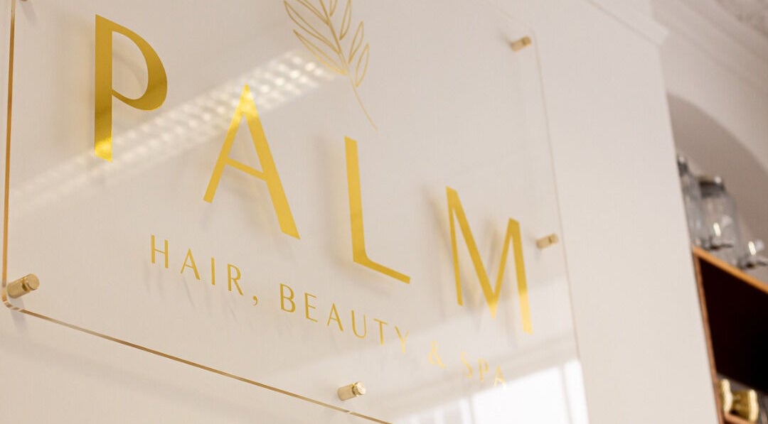 Elegant Palm Spa signage in Torquay, England, GB, showcasing sleek gold lettering on a modern backdrop.