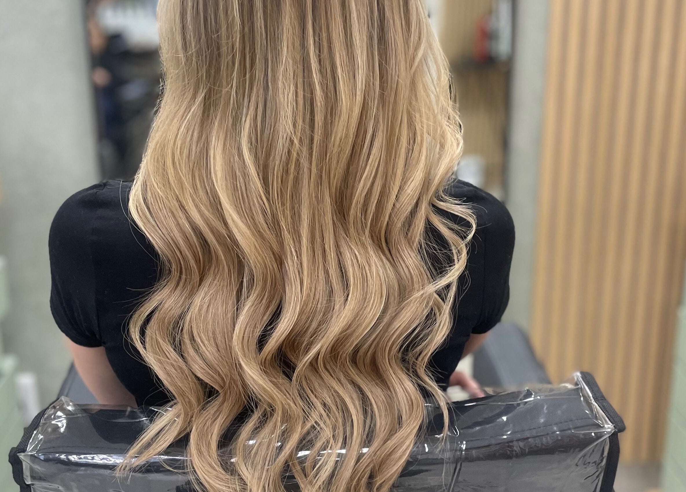 Long, wavy blonde hair at Image Reflections, Johannesburg, Gauteng, ZA salon, showcasing hairstyling expertise.