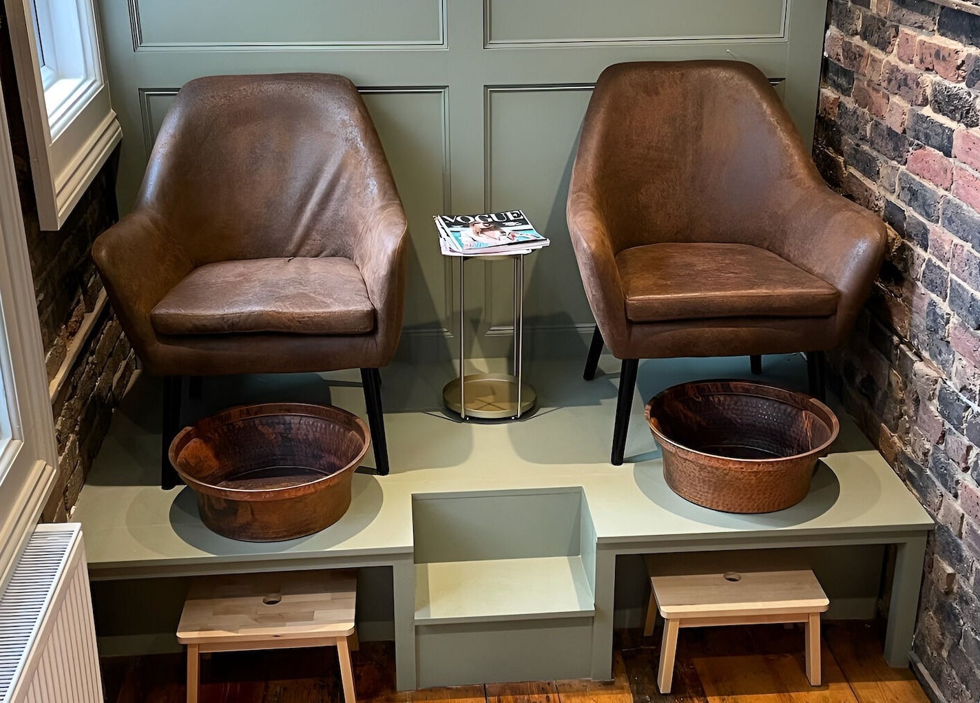 Comfortable pedicure area at Billie’s Brows and Nails, Hastings, England, GB with leather chairs and copper bowls.