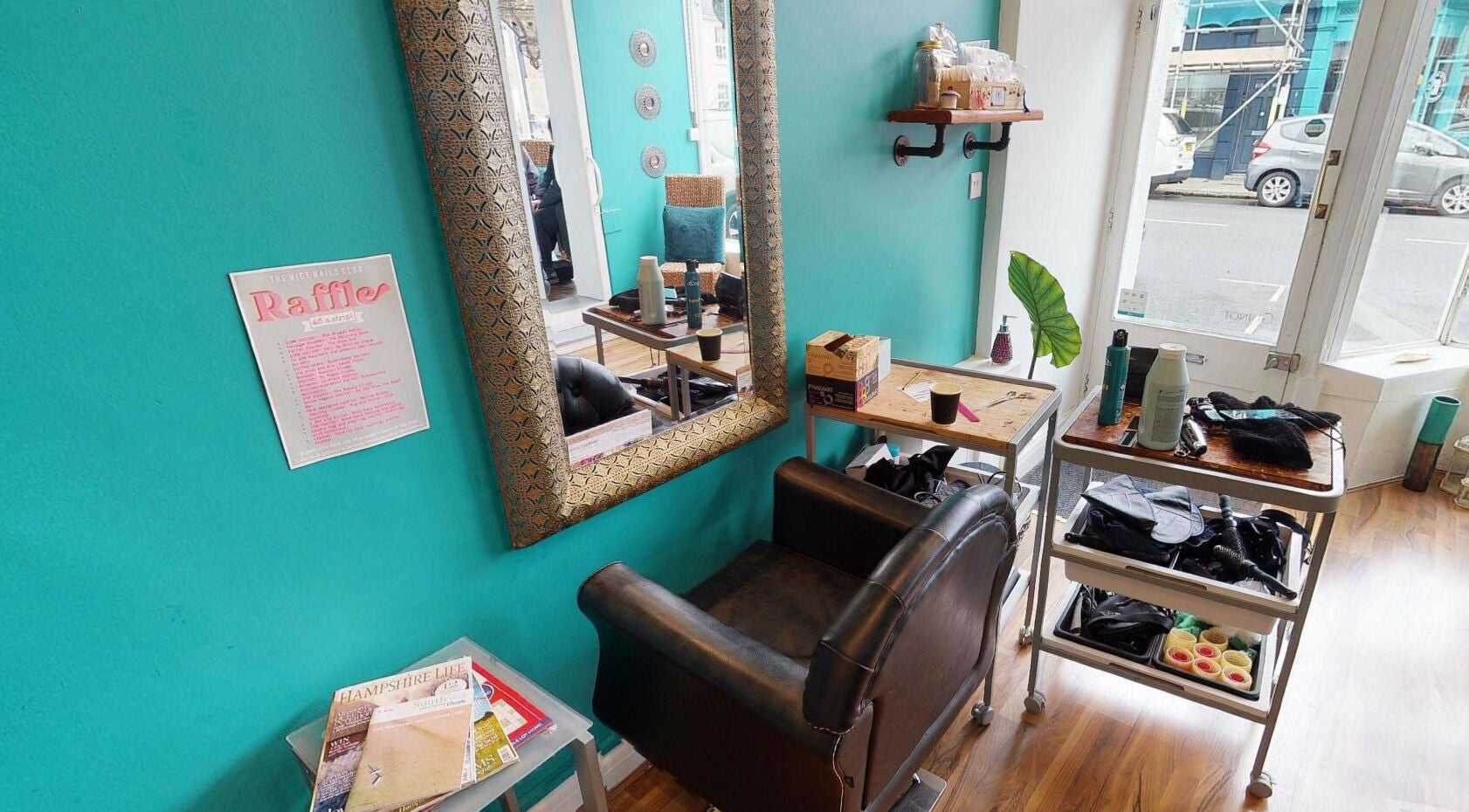 Chic styling area at The Beauty Clinic in Portsmouth, England, GB with turquoise wall and elegant decor.