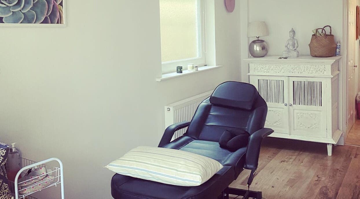 Relaxing massage room at SJ Massage Therapy, Exmouth/Exeter, England, GB, featuring a comfortable black recliner.