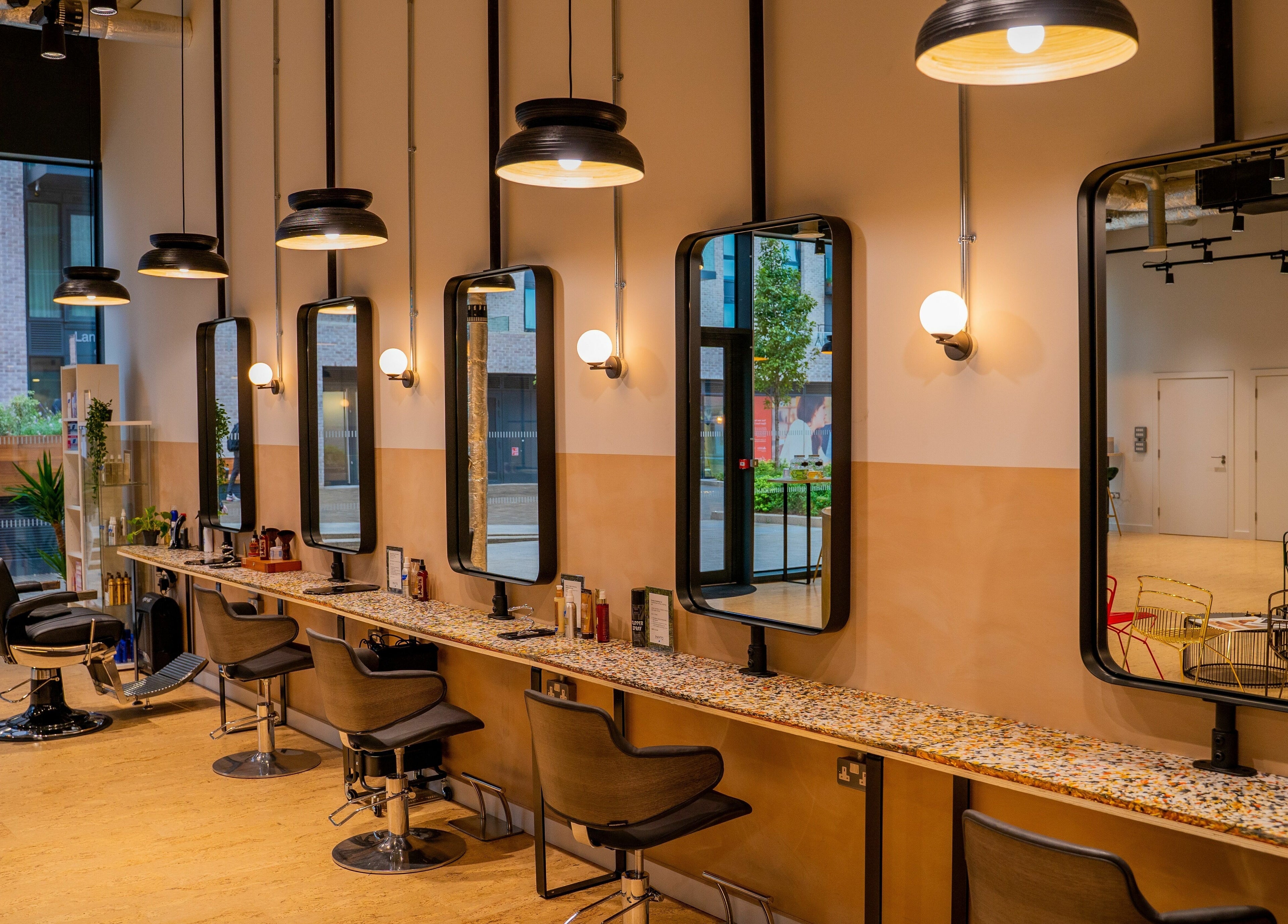 Elegant salon interior at Chop Chop London Wembley Park, Park, London, England, GB featuring stylish mirrors and chairs.